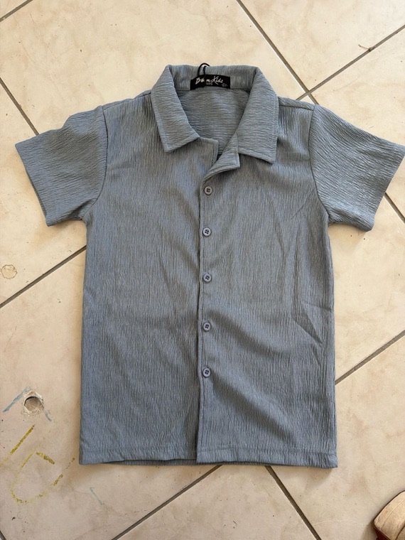 Photo de la chemise prise au téléphone, posée au sol